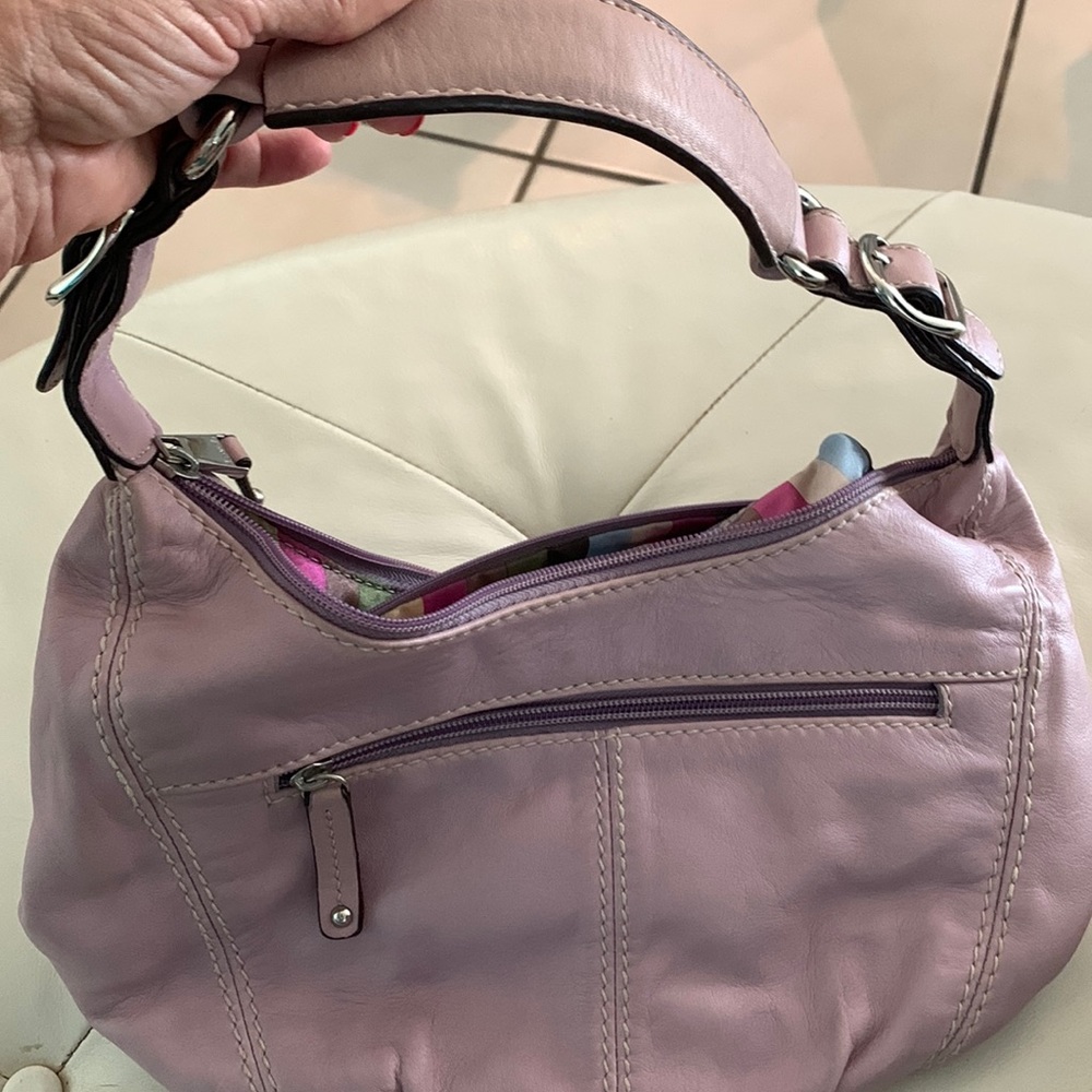 Tignanello soft leather purple bag. Clean interior. Sign of wear. Front spot.